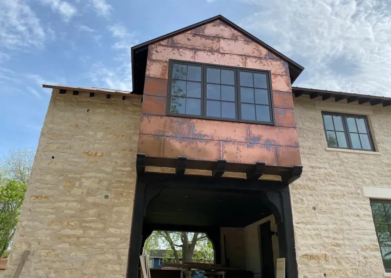 Copper metal panel facade on a stone building for Skylight Installation in Montville