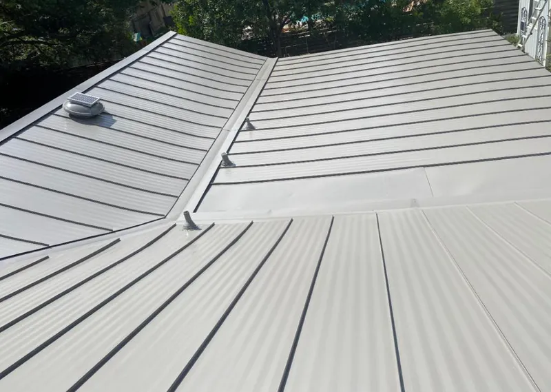 Solar attic fan installed on a metal roof for Roof Ventilation in Montville